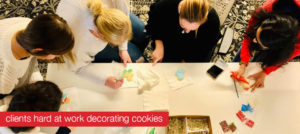 Clients decorating cookies for Schaefer's 2019 Cookies for a Cause campaign.