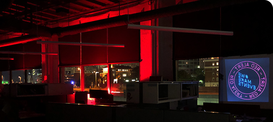 View of Schaefer's downtown Cincinnati office lit up with red lights for Red Alert #RESTART.