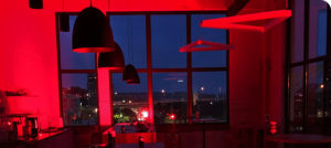 Schaefer's downtown Cincinnati office cafe area lit up with red lights for Red Alert #RESTART.
