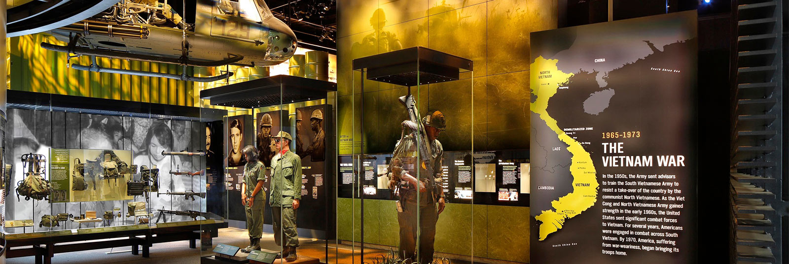 Exhibit space inside the National Museum of the United States Army featuring a helicopter suspended from the ceiling.