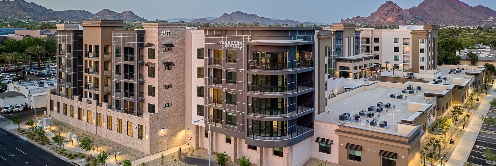 Photo of Clarendale Arcadia senior living community exterior facade with mountains in the background